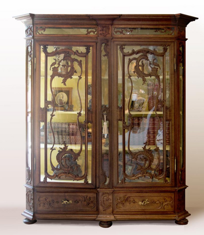 K/L A Liege carved oak cabinet, compriaing two doors over two drawers, beveled corners.